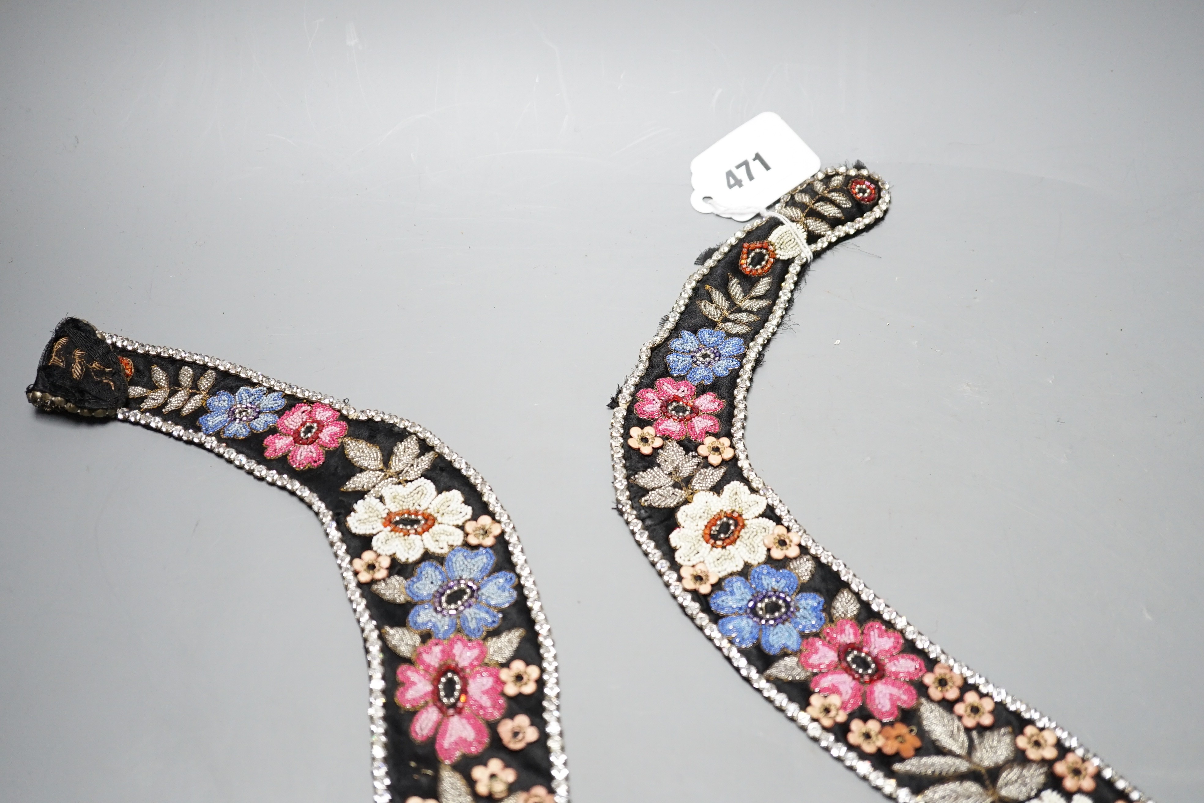 A 1920’s-30’s French beaded collar, the beads embroidered as flowers and leaves with leather applice flowers and diamanté edging, 115 cms long